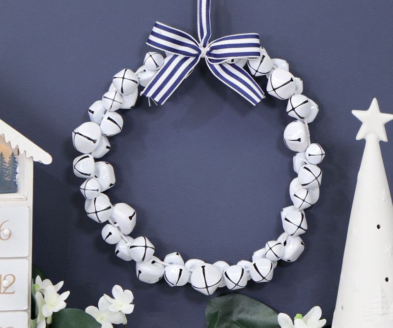 White Jingle Bell Wreath with Blue Bow
