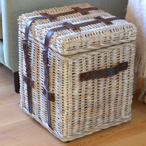 Small square greywashed rattan trunk with dark brown leather straps and side handle