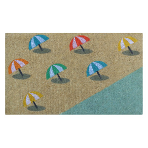Natural coir doormat with colourful beach umbrellas beside a shoreline