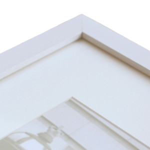 Close up view of white A3 frame with acrylic front and white matt board