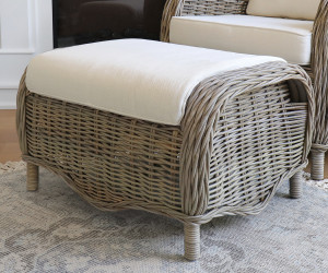 Side view of the curved woven rattan footstool and natural cushion