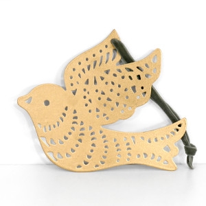 Gold iron dove decoration with patterned cutout wings and an olive green hanging loop against a white background