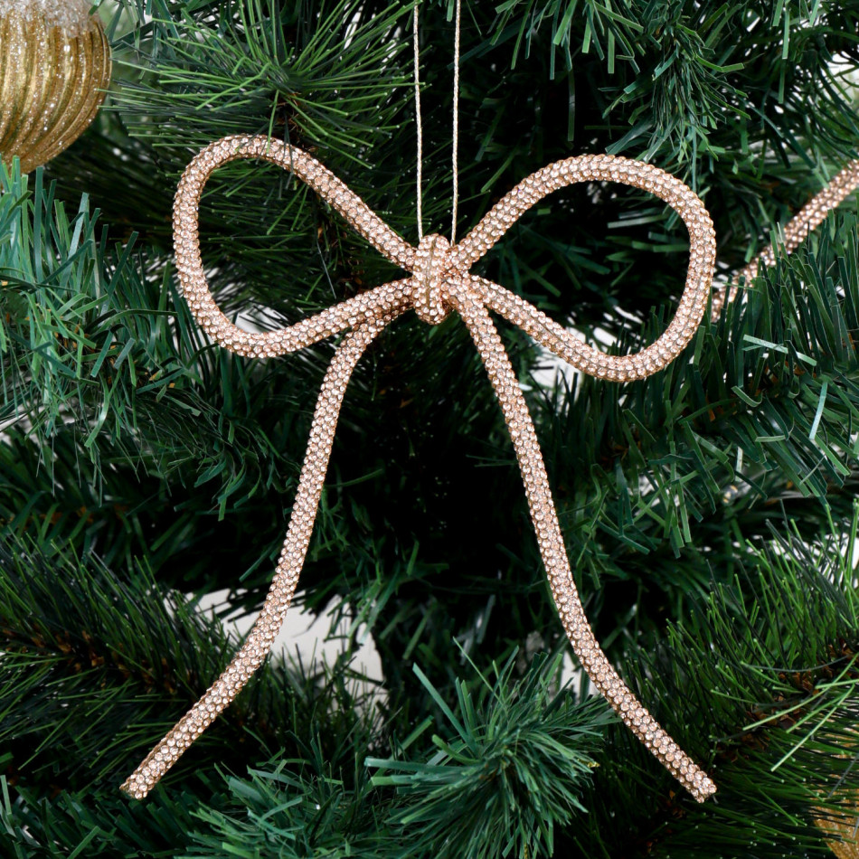 Champagne gold diamante bow with long tails hanging on a green Christmas tree