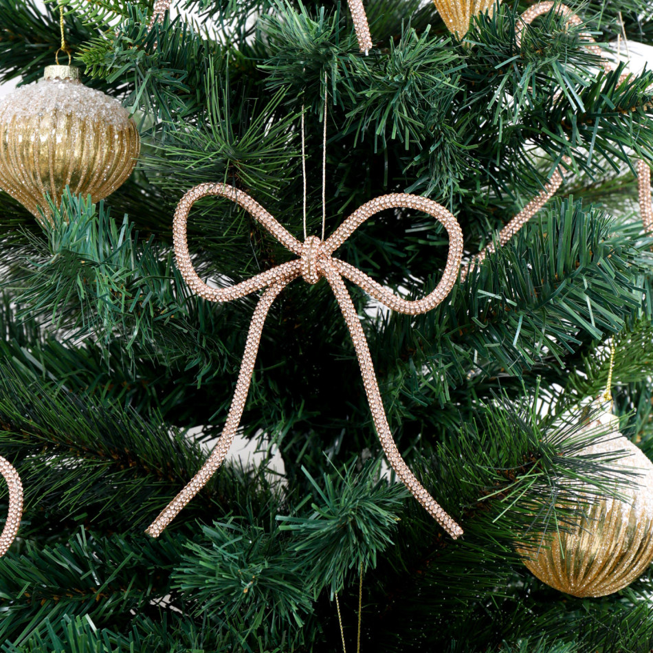 Champagne gold bow decoration displayed among green branches and gold baubles