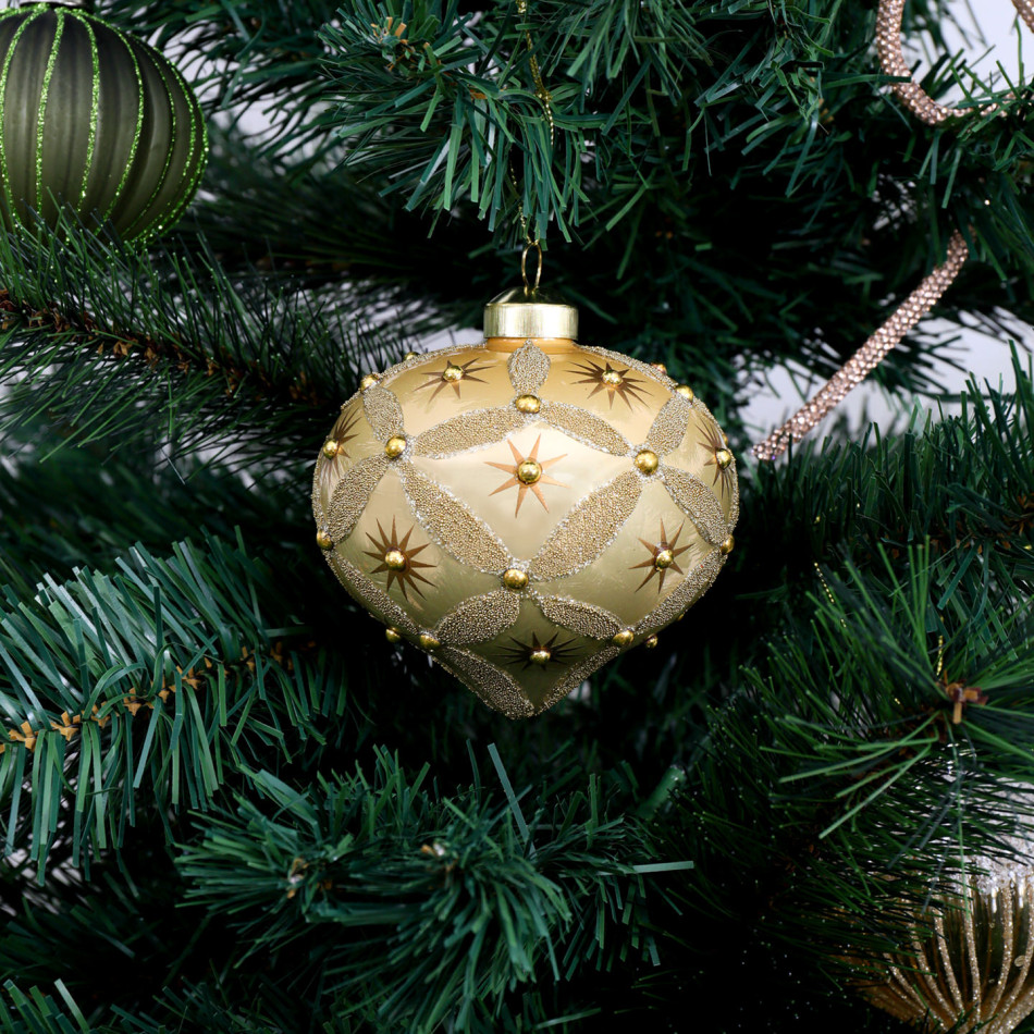 Seraphina gold glass onion decoration hanging among green Christmas tree branches