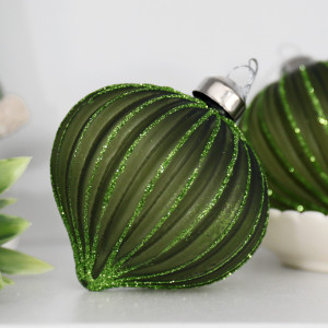 Close-up of a dark green Marissa onion bauble with curved flutes, green glitter lines and a silver cap