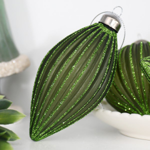 Close-up of a Marissa green glass teardrop bauble with fluted glitter detailing and a silver cap