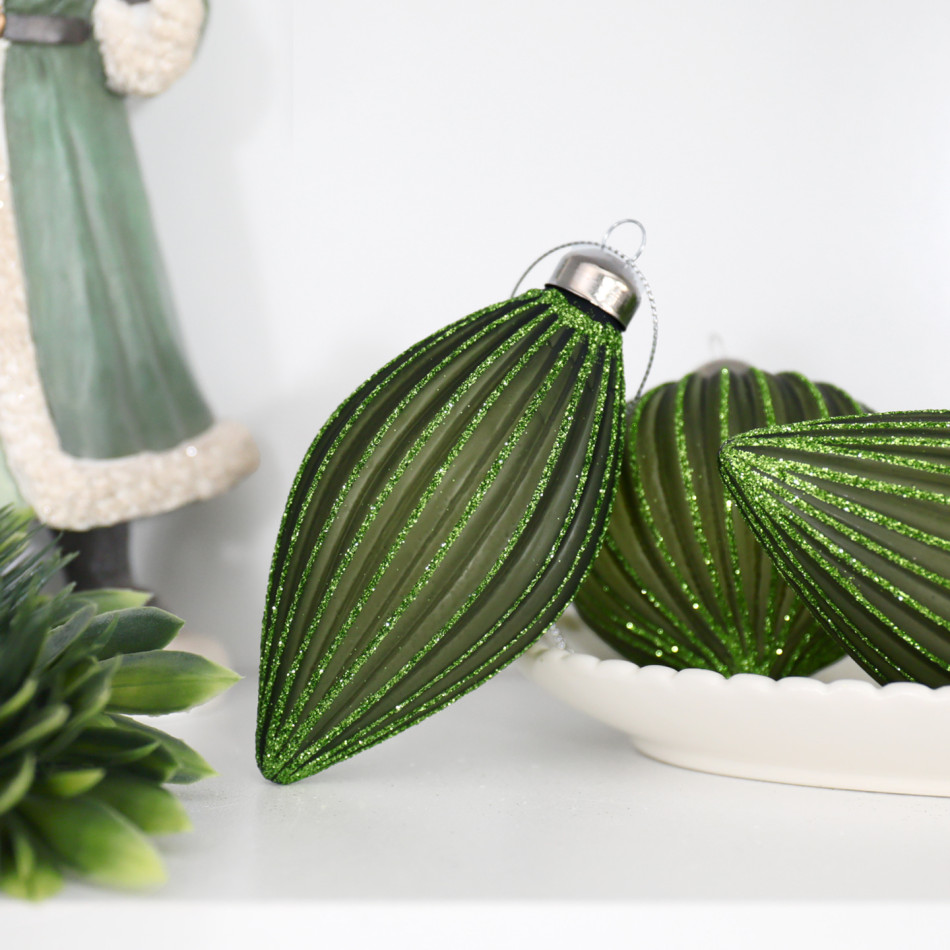 Marissa green teardrop bauble displayed with matching onion ornaments, foliage and a green Santa figure