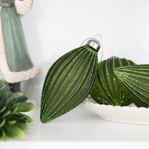 Marissa green teardrop bauble displayed with matching onion ornaments, foliage and a green Santa figure
