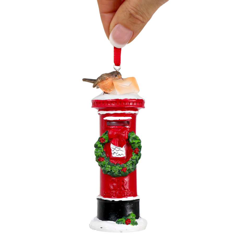 London mailbox Christmas ornament with snow-effect details and a red ribbon against a white background