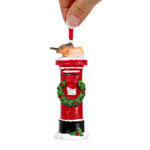 London mailbox Christmas ornament with snow-effect details and a red ribbon against a white background
