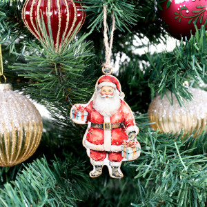 Vintage Tin Santa II Christmas decoration hanging among red and gold baubles on a green tree
