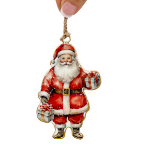 Double-sided metal Santa ornament held by its twine hanging loop against a white background