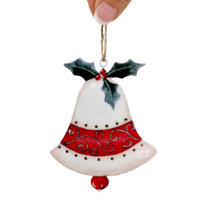 Vintage bell Christmas decoration held by its hanging loop against white, showing red scrollwork and holly details