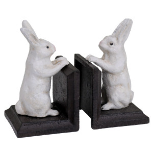 Angled view of the set of two cast iron bunny bookends with white rabbits and dark brown bases