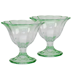Set of two translucent green glass dessert bowls with fluted sides, scalloped rims and pedestal bases