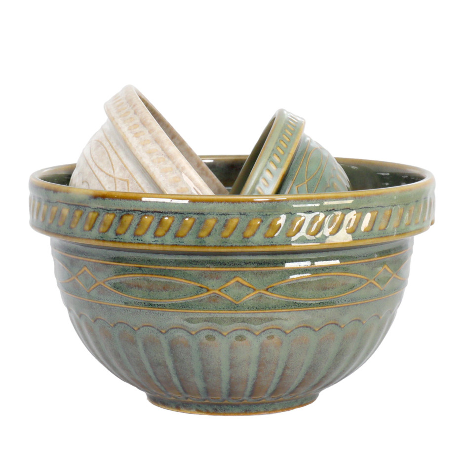 Set of three green and cream ceramic mixing bowls on a white background