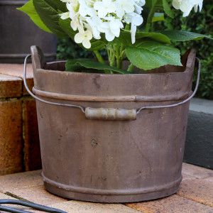 Close-up of the reclaimed wood grain and metal bands on the Hartwell bucket