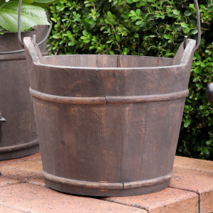 Close-up of the aged wood grain and metal band detailing on the barrel bucket