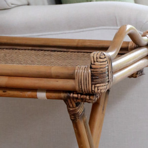Close-up of the brown rattan tray showing its woven surface, curved handle and wrapped corners