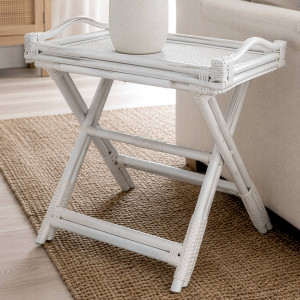 White rattan butler's tray table with raised handles styled beside a cream sofa