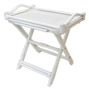 Angled view of the white rattan tray table showing its folding cross-frame base