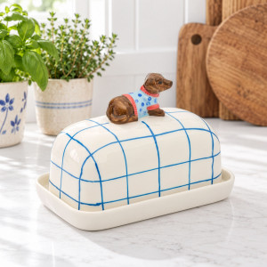 Blue and white checked dog butter dish styled with herbs and timber boards