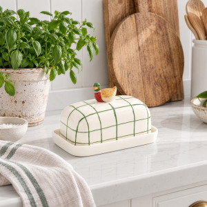 Dante Duck Butter Dish styled on a kitchen bench with herbs and green striped linen
