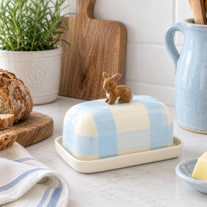 Rosie Rabbit butter dish styled beside fresh bread and pale blue kitchenware