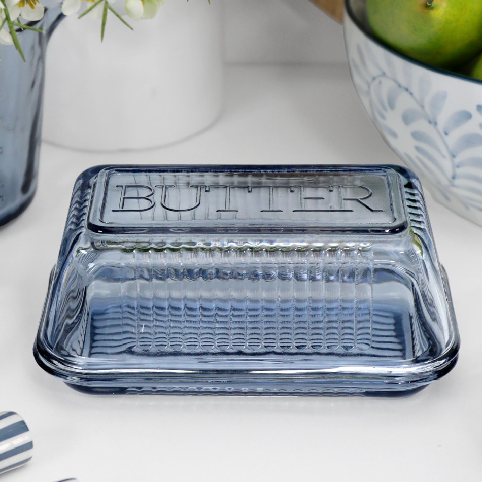 Heritage Blue Glass Butter Dish styled on a white kitchen bench with coordinating blue glassware