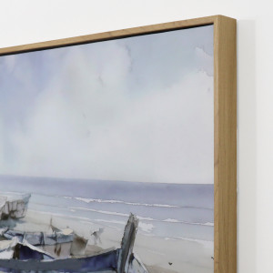 Close-up of the Bradley Bay canvas showing the natural wood look frame and pale blue coastal scene