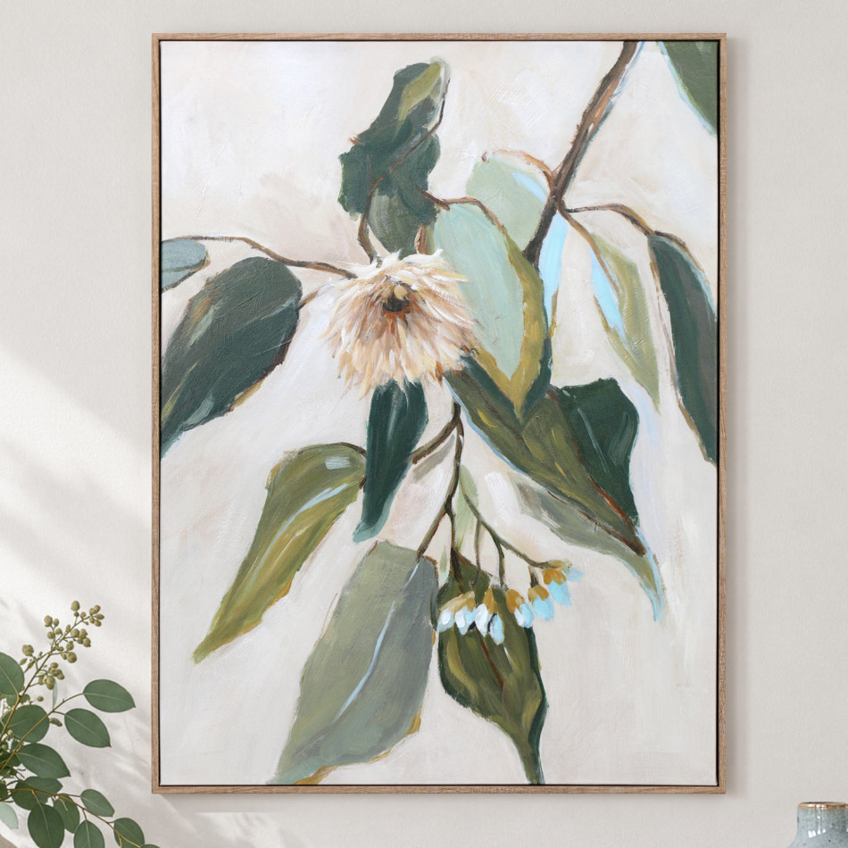 Framed eucalyptus canvas painting with green leaves and a pale blush flower displayed on a light wall
