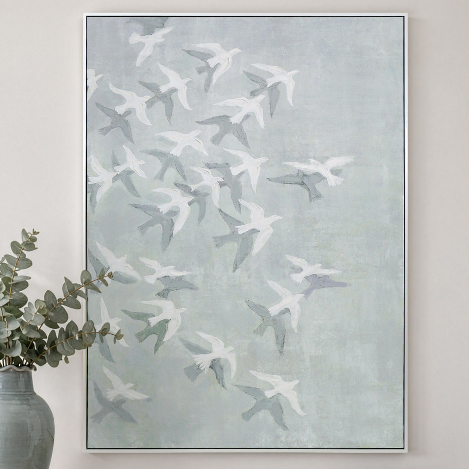 White-framed bird canvas with pale blue-green tones, styled beside eucalyptus in a glazed vase