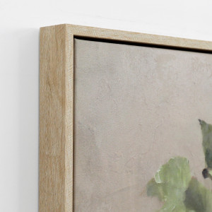 Close-up of a natural-coloured frame and textured canvas showing the frame profile and green leaf detail