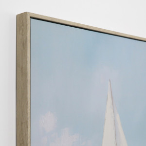Angled close-up of the natural-coloured frame, pale blue sky and handpainted detail on the yacht canvas