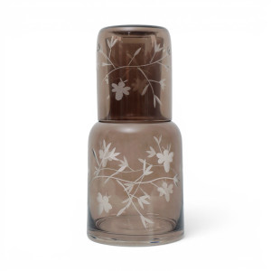 Chestnut-brown botanical and bee etched tumbler stored upside down on the matching glass carafe