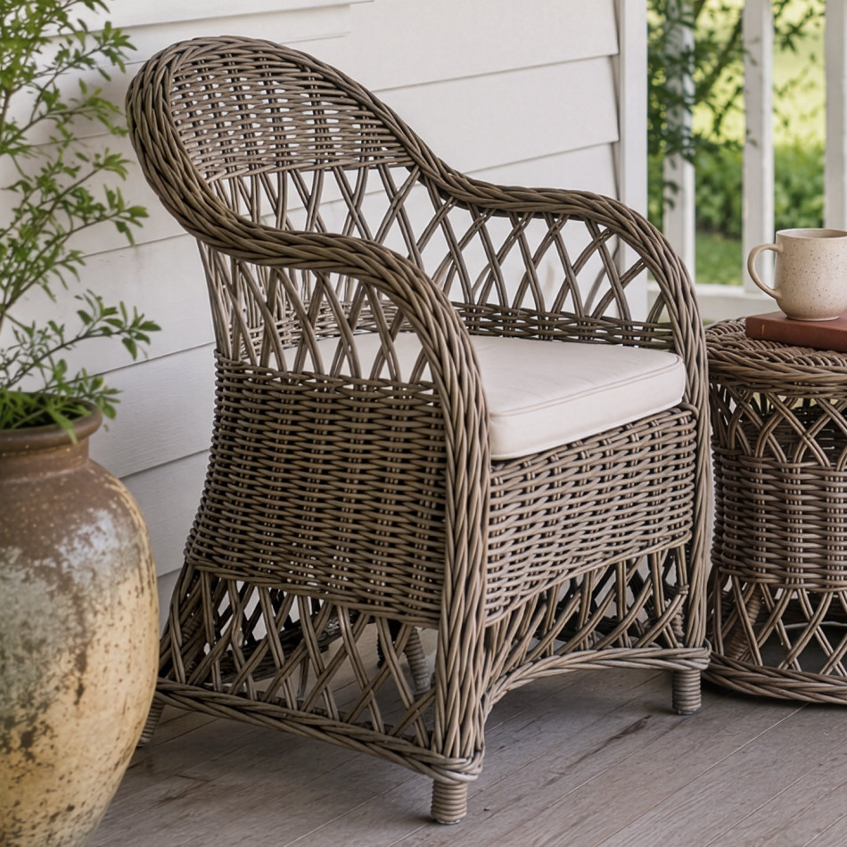 Clifton grey-brown rattan chair with cream seat cushion styled on a covered verandah