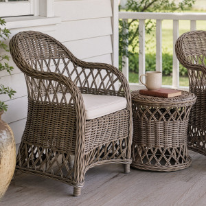 Clifton rattan chair beside a coordinating round rattan side table