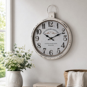 Country cottage wall clock styled beside a window, flower arrangement and woven basket