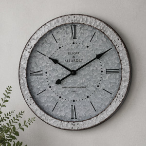 Marlesford round metal wall clock with Roman numerals and a rustic riveted frame