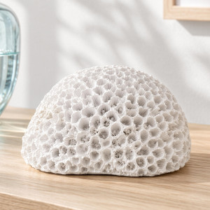 Close-up of white Hayman faux brain coral on a timber surface, showing its detailed ridges and hollows