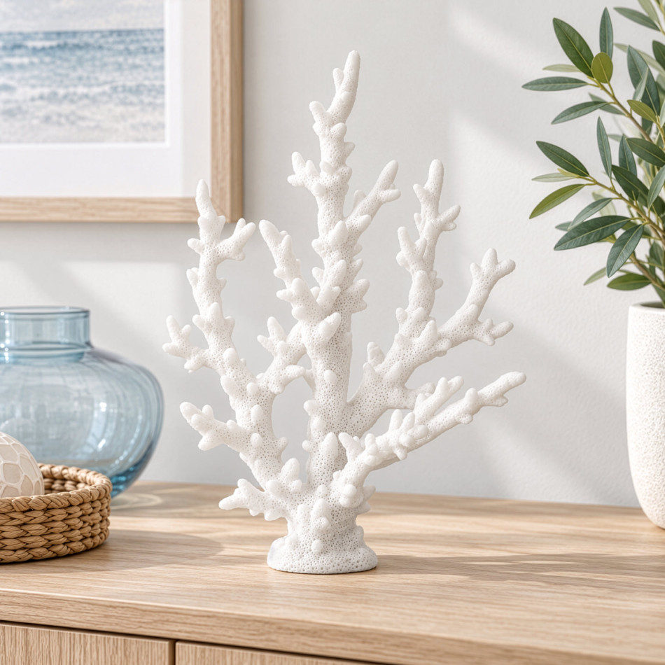 Close view of white resin finger coral with textured branches, styled beside a blue glass vase
