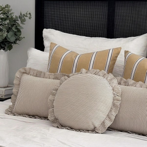 Round Bonnie Taupe & White Ruffle Cushion, shown as a soft decorative accent for layering on seating or a bed