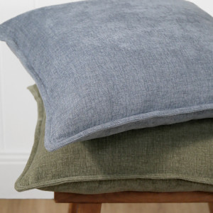 Hudson Chambray Cushion - Denim Blue, shown as a soft decorative accent for layering on seating or a bed