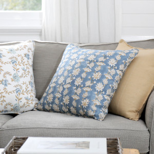 Saffira Blooms Blue Linen Cushion, shown as a soft decorative accent for layering on seating or a bed
