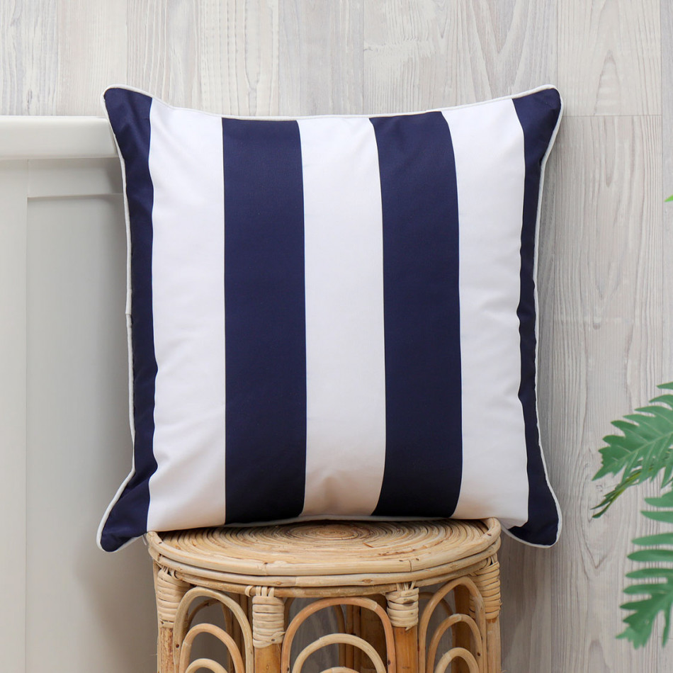 Nantucket navy stripe outdoor cushion styled as a soft decorative seating accent