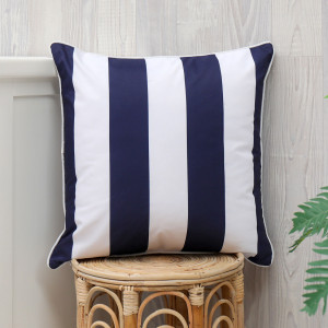 Nantucket navy stripe outdoor cushion styled as a soft decorative seating accent
