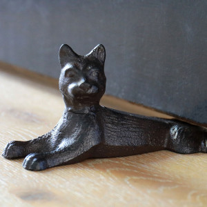 Cassie the Cat Door Wedge, a decorative floor accent made to keep a door securely positioned