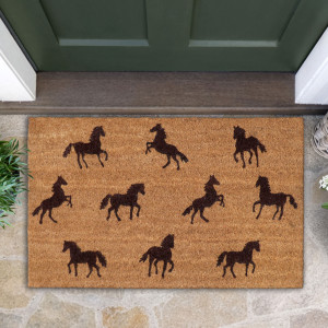 Natural coir doormat with dark brown horse silhouettes on stone paving below a green front door