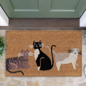 Close-up of a natural coir doormat featuring three illustrated cats beside a green front door